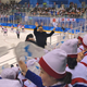 A Kim Jong-un impersonator stands next to the North Korean cheerleaders.